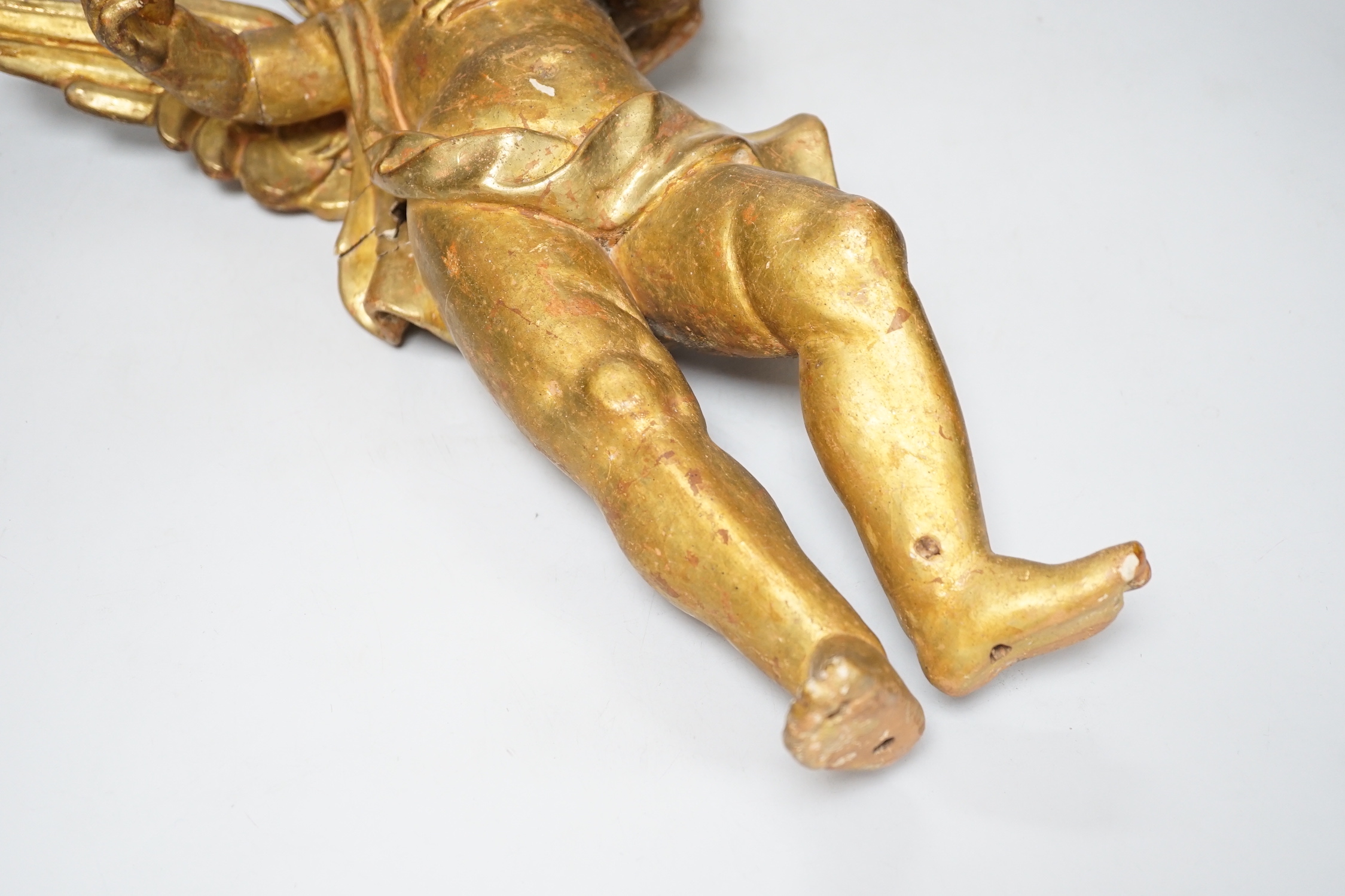 DO NOT RE-OFFER A Florentine carved gilt wood amorini, 39cm high